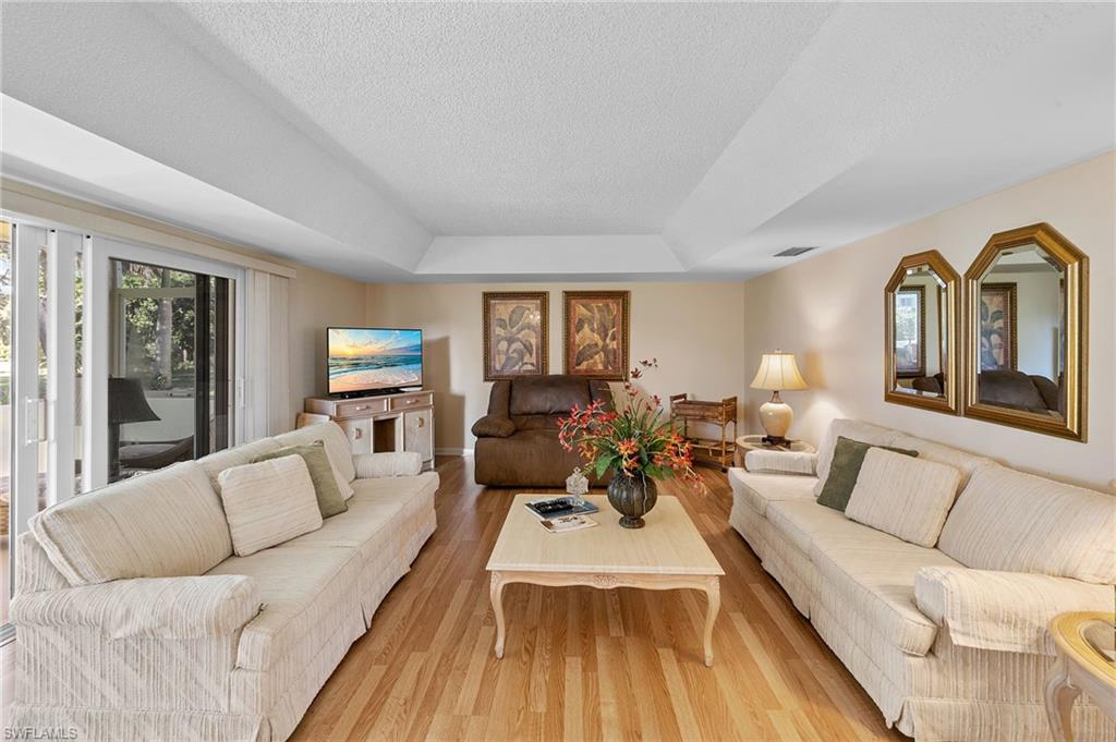 817 Teryl Road, Unit 1 Naples, FL 34112 - Photo 17 of 47 a living room with furniture fireplace and a large window