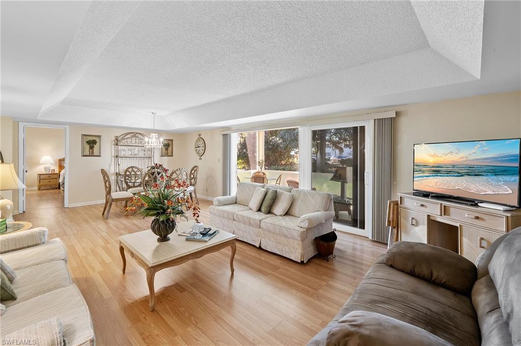 817 Teryl Road, Unit 1 Naples, FL 34112 - Photo 18 of 47 a living room with furniture flat screen tv and couches