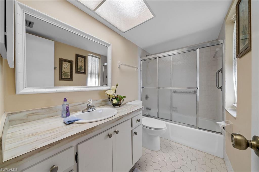 817 Teryl Road, Unit 1 Naples, FL 34112 - Photo 19 of 47 a bathroom with a granite countertop sink a toilet and shower