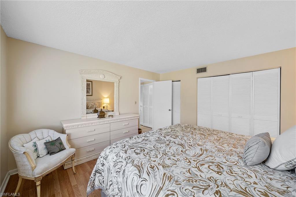 817 Teryl Road, Unit 1 Naples, FL 34112 - Photo 21 of 47 a bedroom with a bed and chair