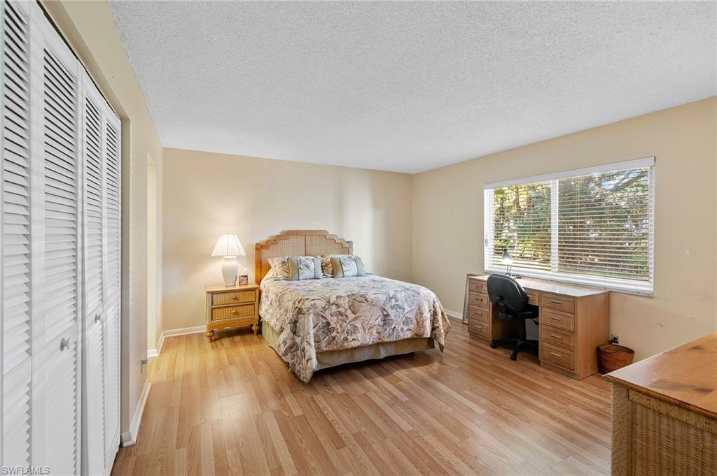 817 Teryl Road, Unit 1 Naples, FL 34112 - Photo 23 of 47 a bedroom with a bed and wooden floor
