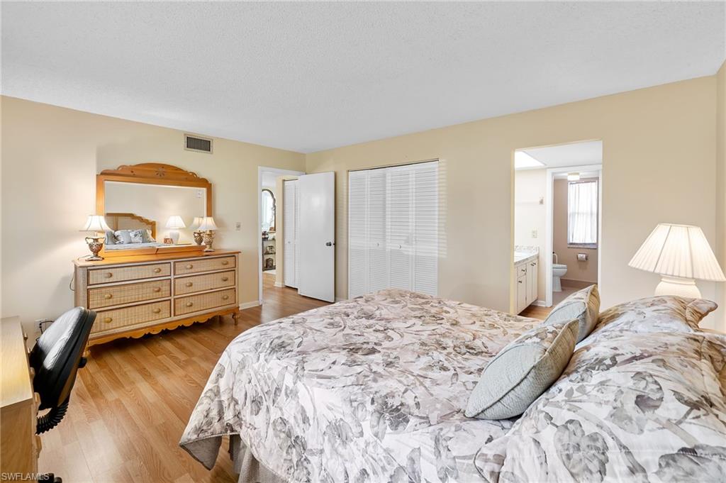 817 Teryl Road, Unit 1 Naples, FL 34112 - Photo 24 of 47 a bedroom with a bed and a closet