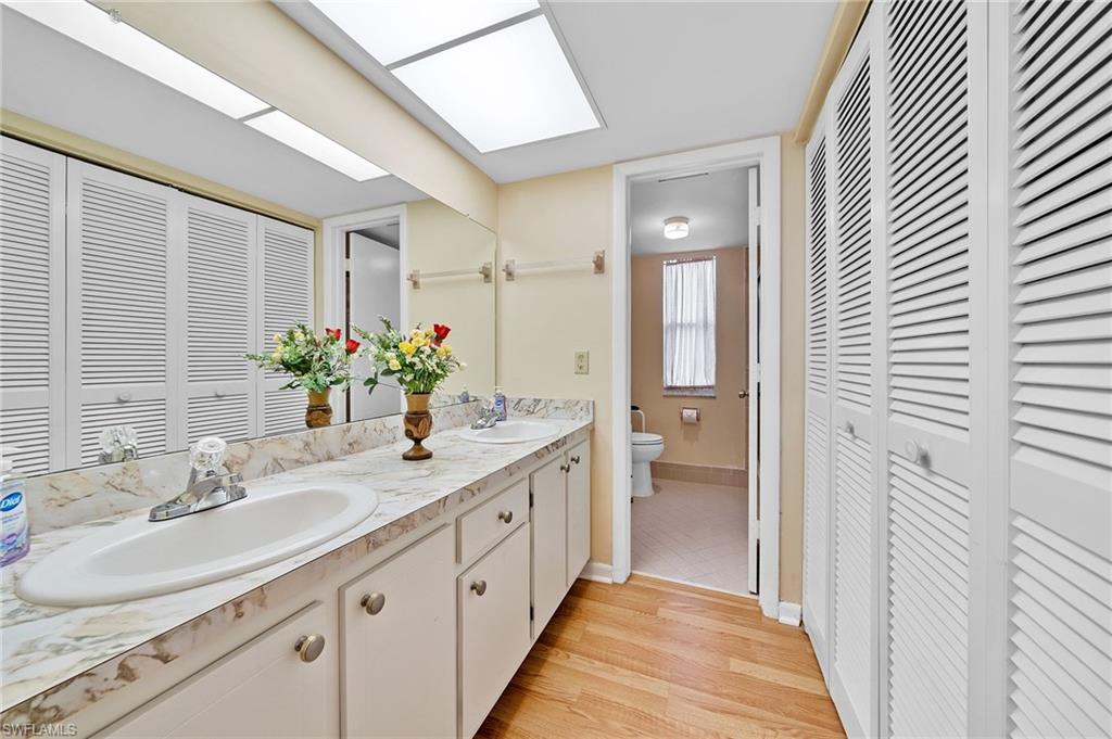 817 Teryl Road, Unit 1 Naples, FL 34112 - Photo 25 of 47 a bathroom with a double vanity sink and a mirror