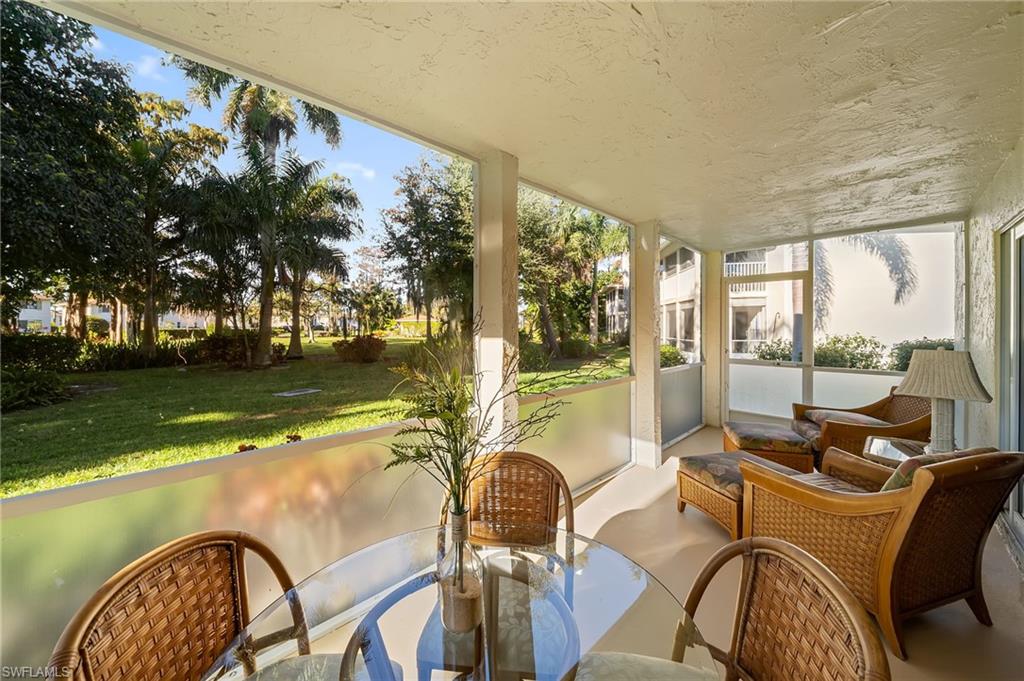 817 Teryl Road, Unit 1 Naples, FL 34112 - Photo 26 of 47 a dining room with furniture and a floor to ceiling window