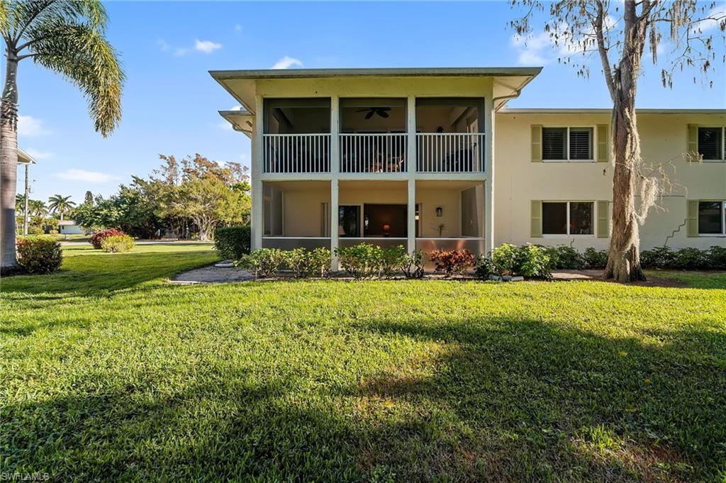 817 Teryl Road, Unit 1 Naples, FL 34112 - Photo 31 of 47 a front view of house with yard and green space