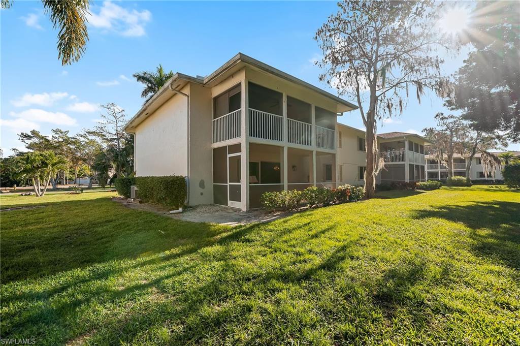 817 Teryl Road, Unit 1 Naples, FL 34112 - Photo 32 of 47 a view of a house with a yard