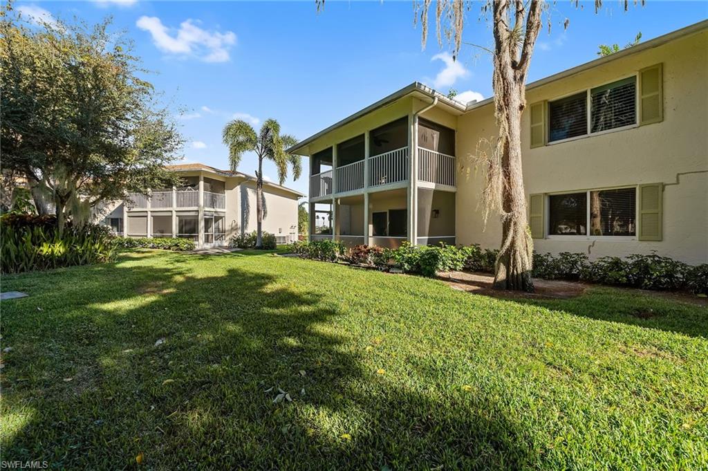 817 Teryl Road, Unit 1 Naples, FL 34112 - Photo 33 of 47 a front view of a house with a yard