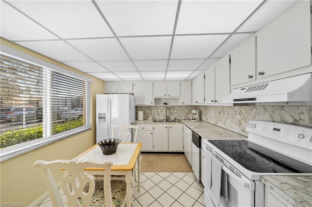 817 Teryl Road, Unit 1 Naples, FL 34112 - Photo 7 of 47 a kitchen with a cabinets and window