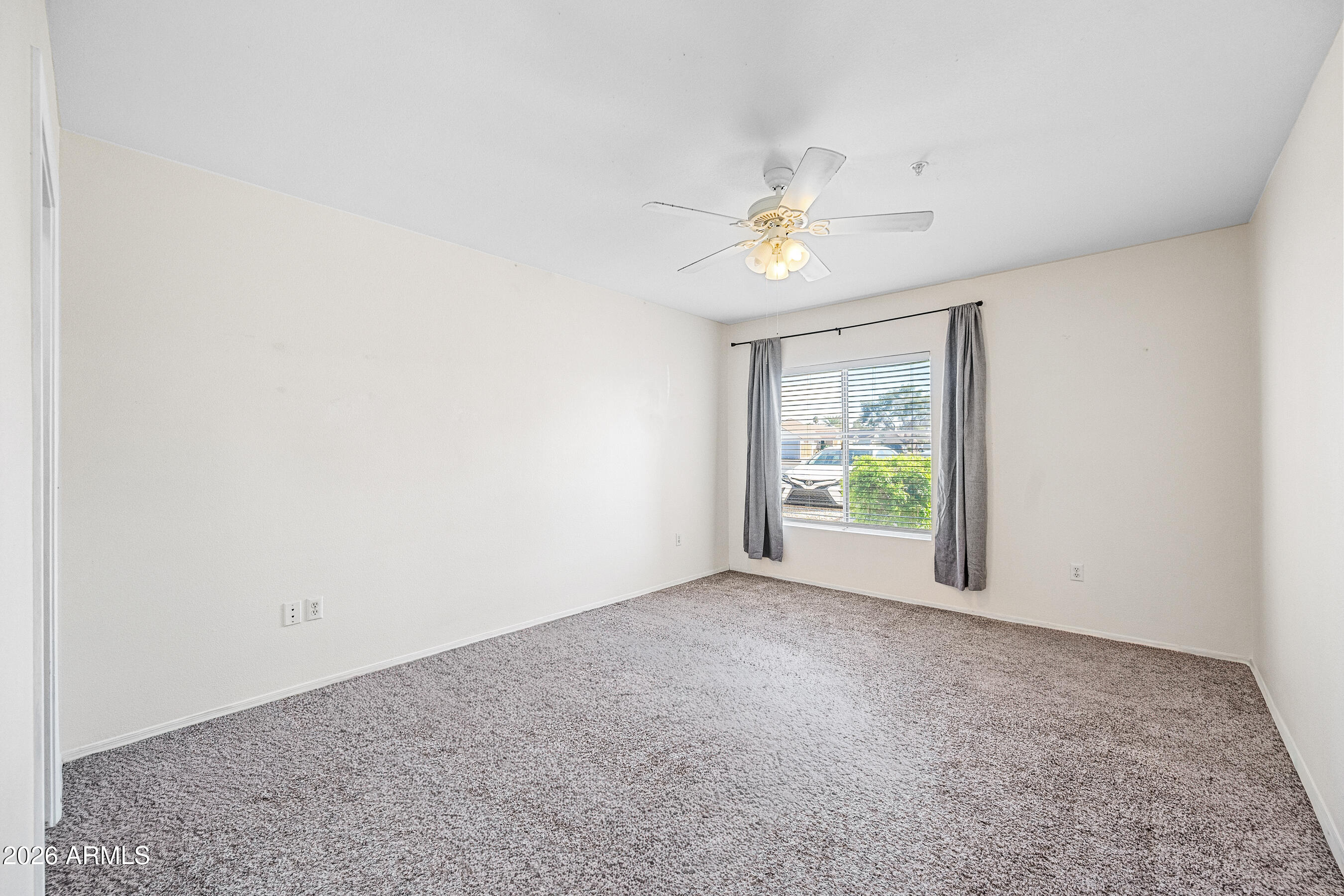 1295 North Ash Street, Unit 617 Gilbert, AZ 85233 - Photo 12 of 21 an empty room with windows and ceiling fan