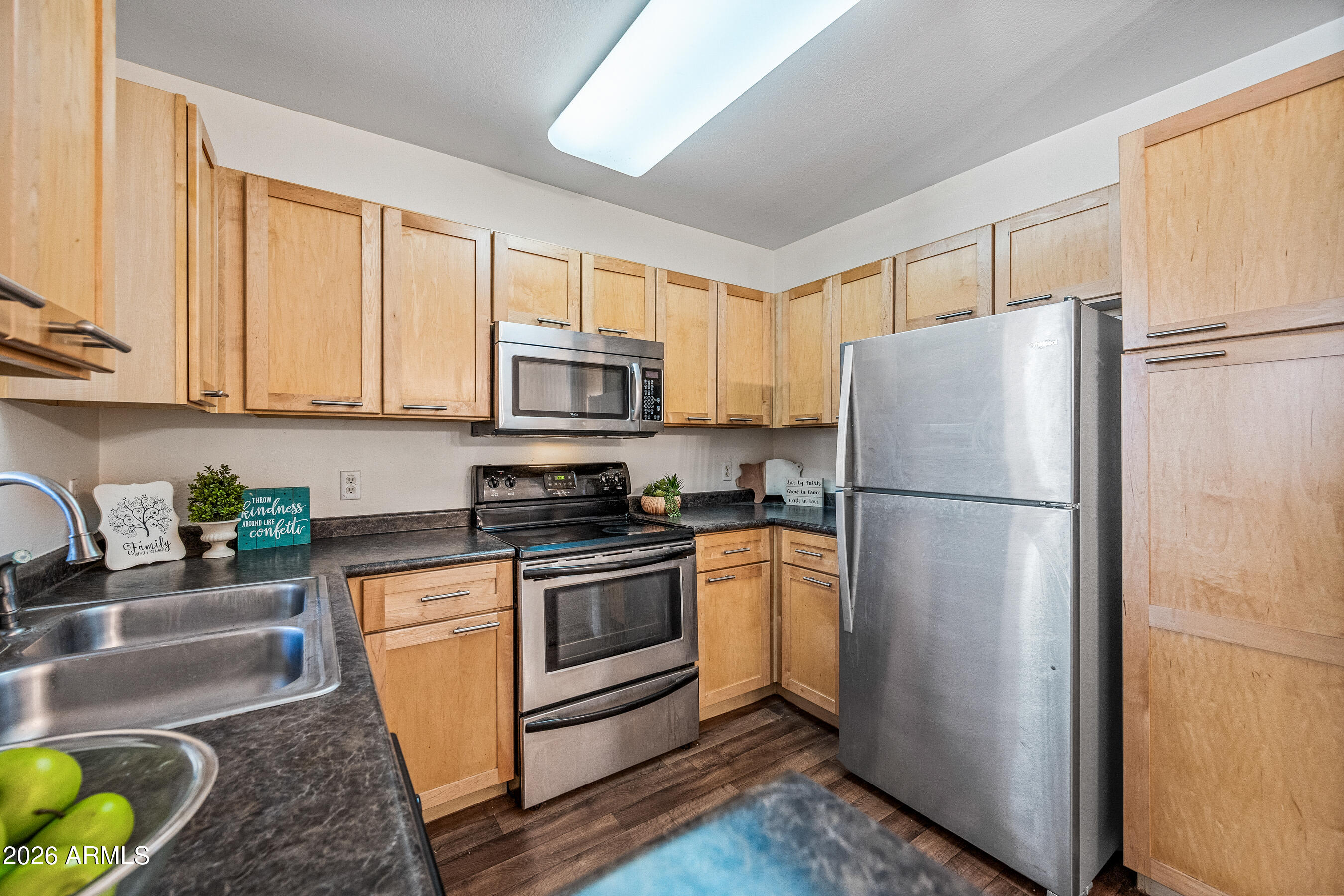 1295 North Ash Street, Unit 617 Gilbert, AZ 85233 - Photo 2 of 21 a kitchen with stainless steel appliances granite countertop a refrigerator a stove a sink a washer and dryer