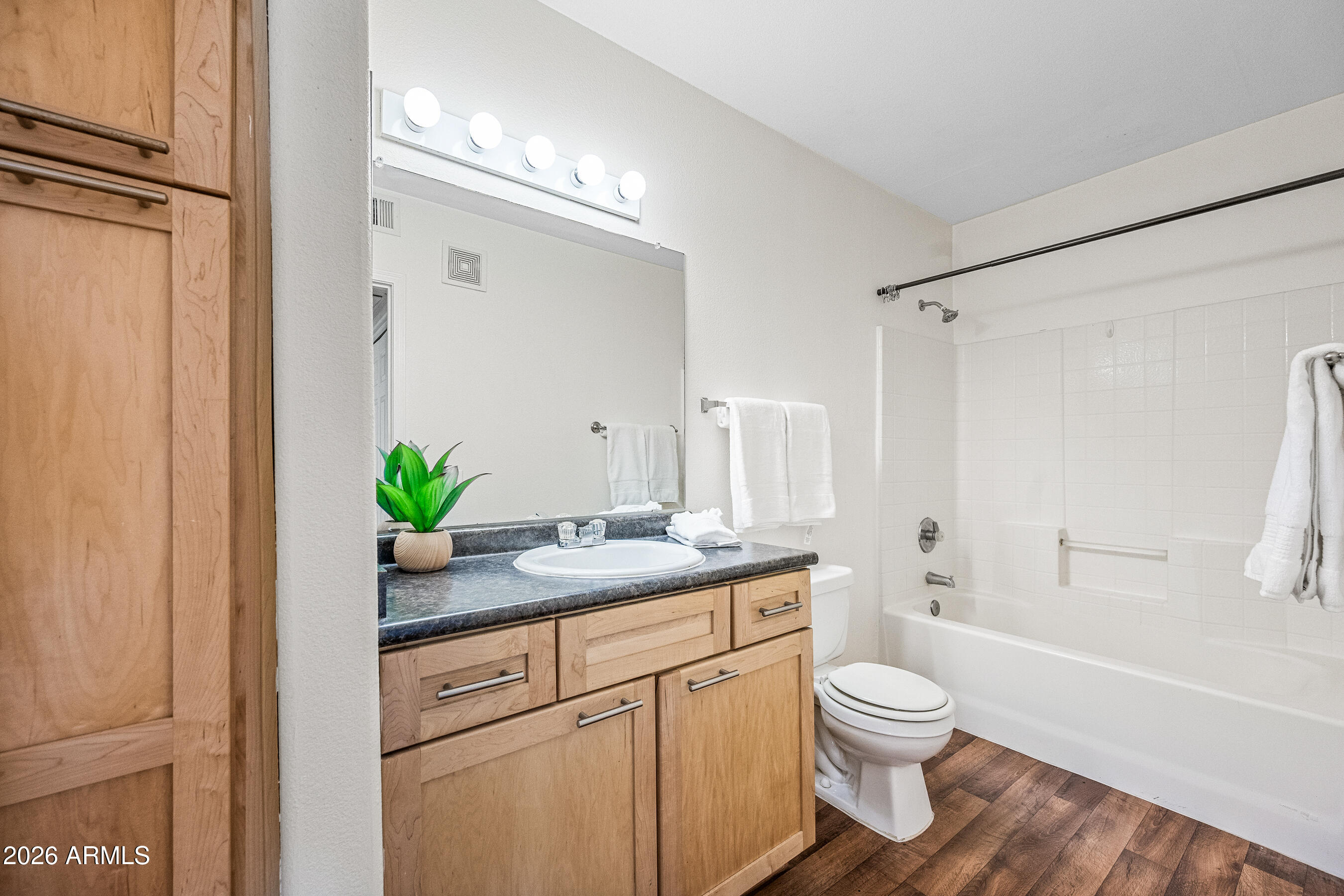 1295 North Ash Street, Unit 617 Gilbert, AZ 85233 - Photo 4 of 21 a bathroom with a granite countertop sink a toilet and shower