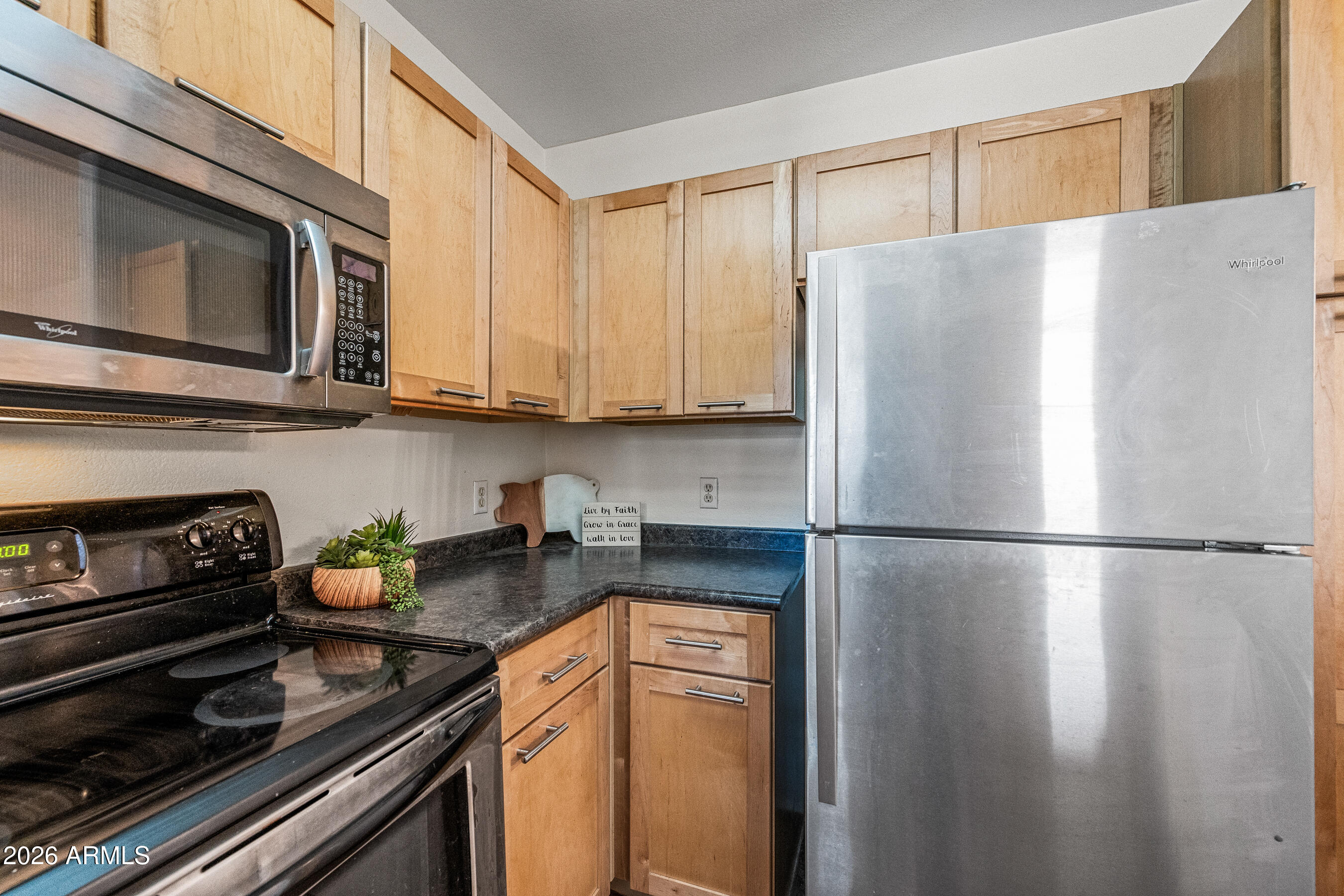 1295 North Ash Street, Unit 617 Gilbert, AZ 85233 - Photo 9 of 21 a white refrigerator freezer sitting in a kitchen