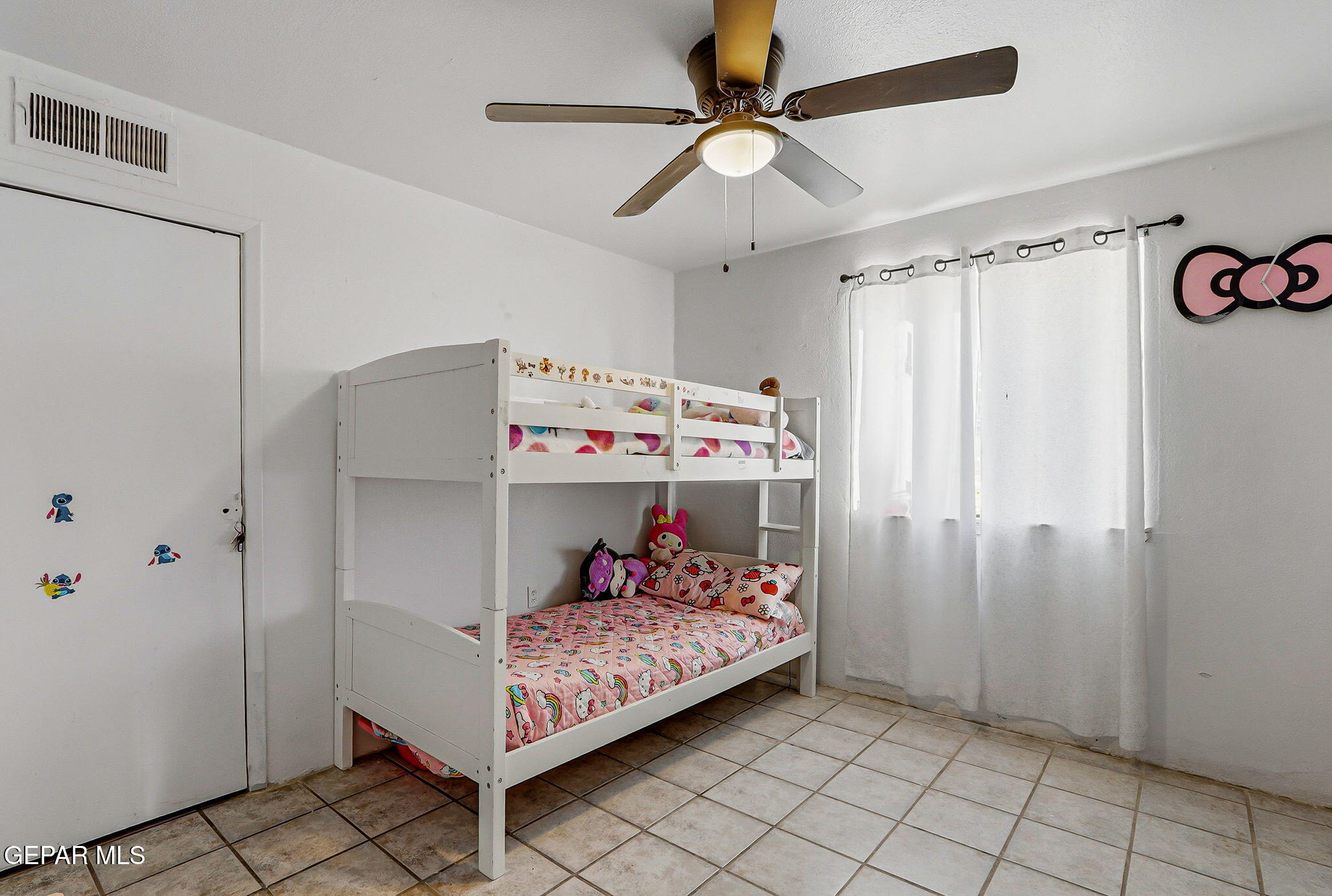 10540 Socorro Road Socorro, TX 79927 - Photo 12 of 45 a bedroom with a bed and a ceiling fan