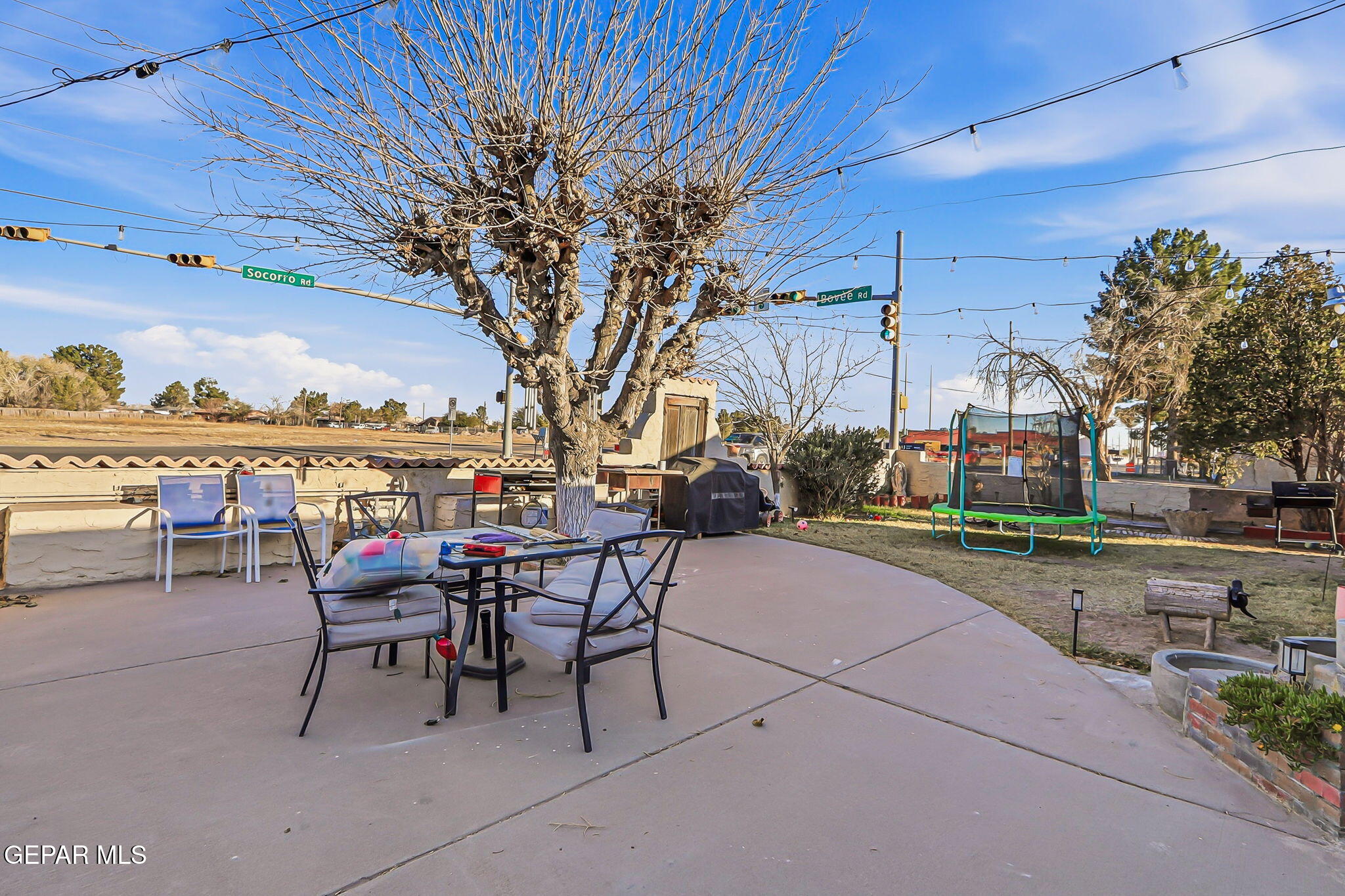 10540 Socorro Road Socorro, TX 79927 - Photo 14 of 45 a patio with a table and chairs and a barbeque