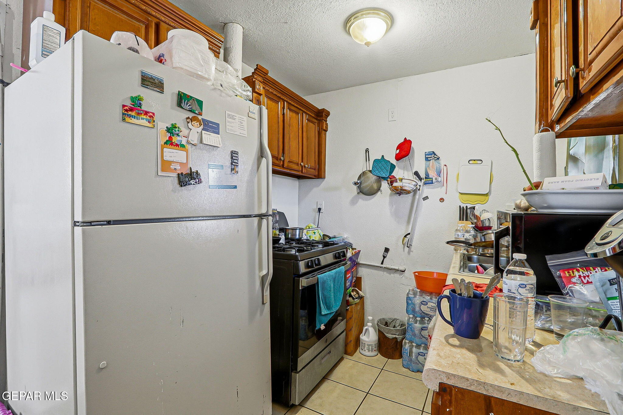 10540 Socorro Road Socorro, TX 79927 - Photo 21 of 45 a white refrigerator freezer sitting inside of a kitchen