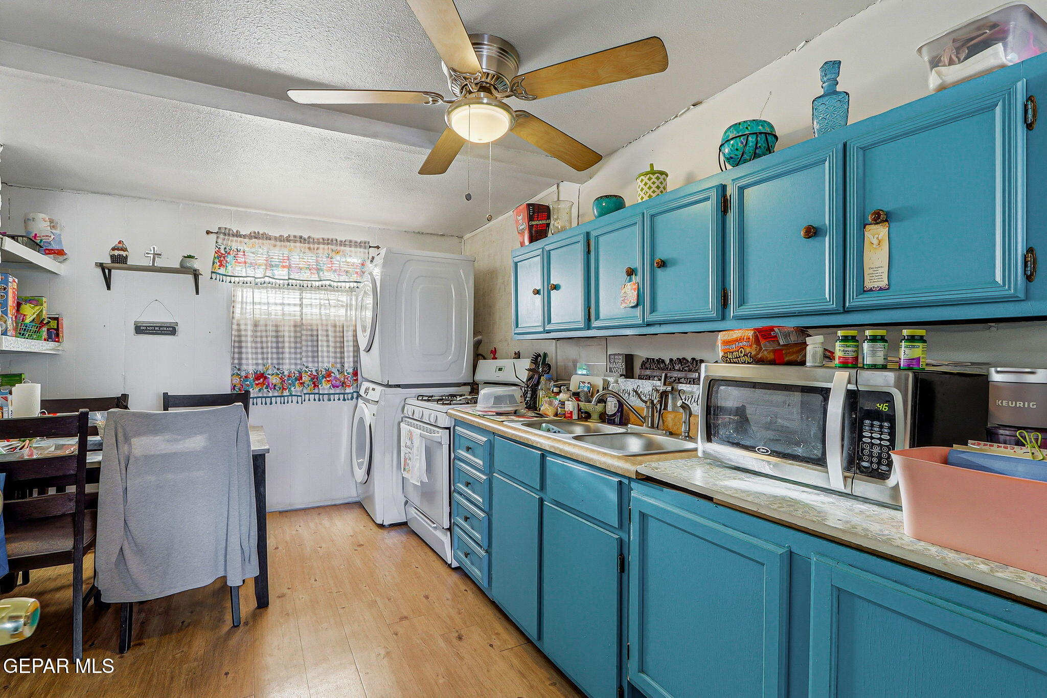 10540 Socorro Road Socorro, TX 79927 - Photo 27 of 45 a kitchen with cabinets and wooden floors