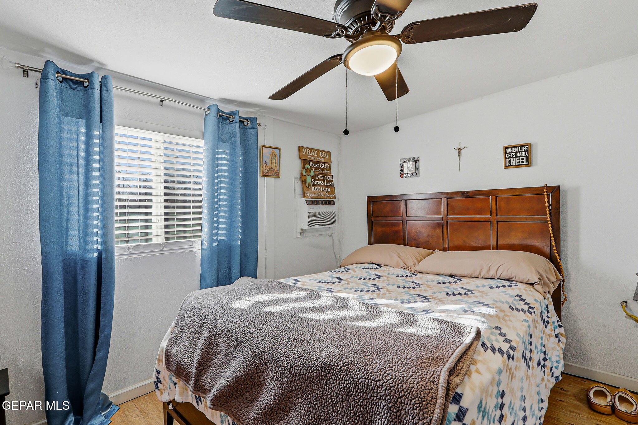 10540 Socorro Road Socorro, TX 79927 - Photo 33 of 45 a bedroom with a bed and a chandelier