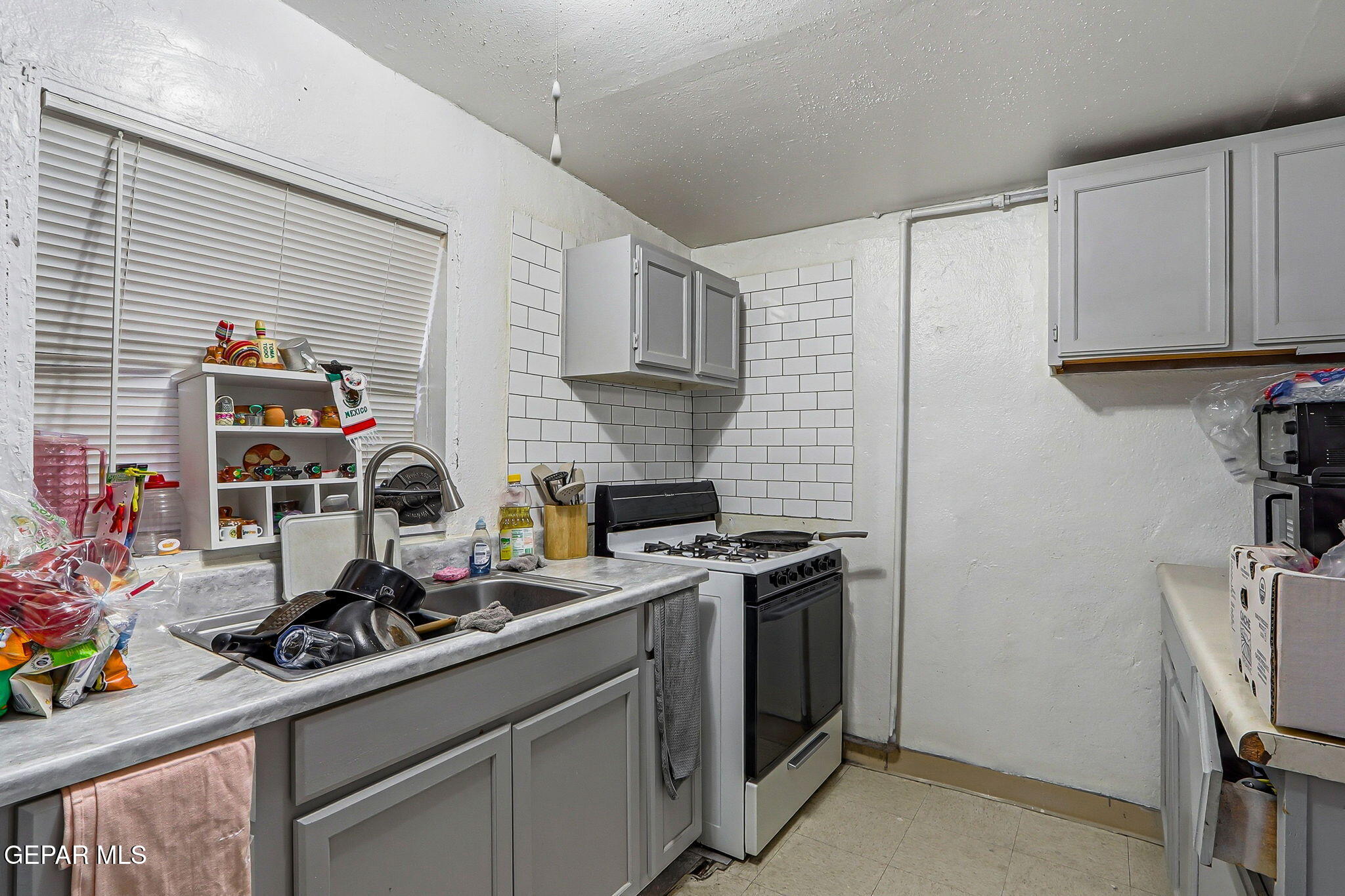 10540 Socorro Road Socorro, TX 79927 - Photo 35 of 45 a kitchen with stainless steel appliances a stove a sink wooden floor cabinets and a dining table