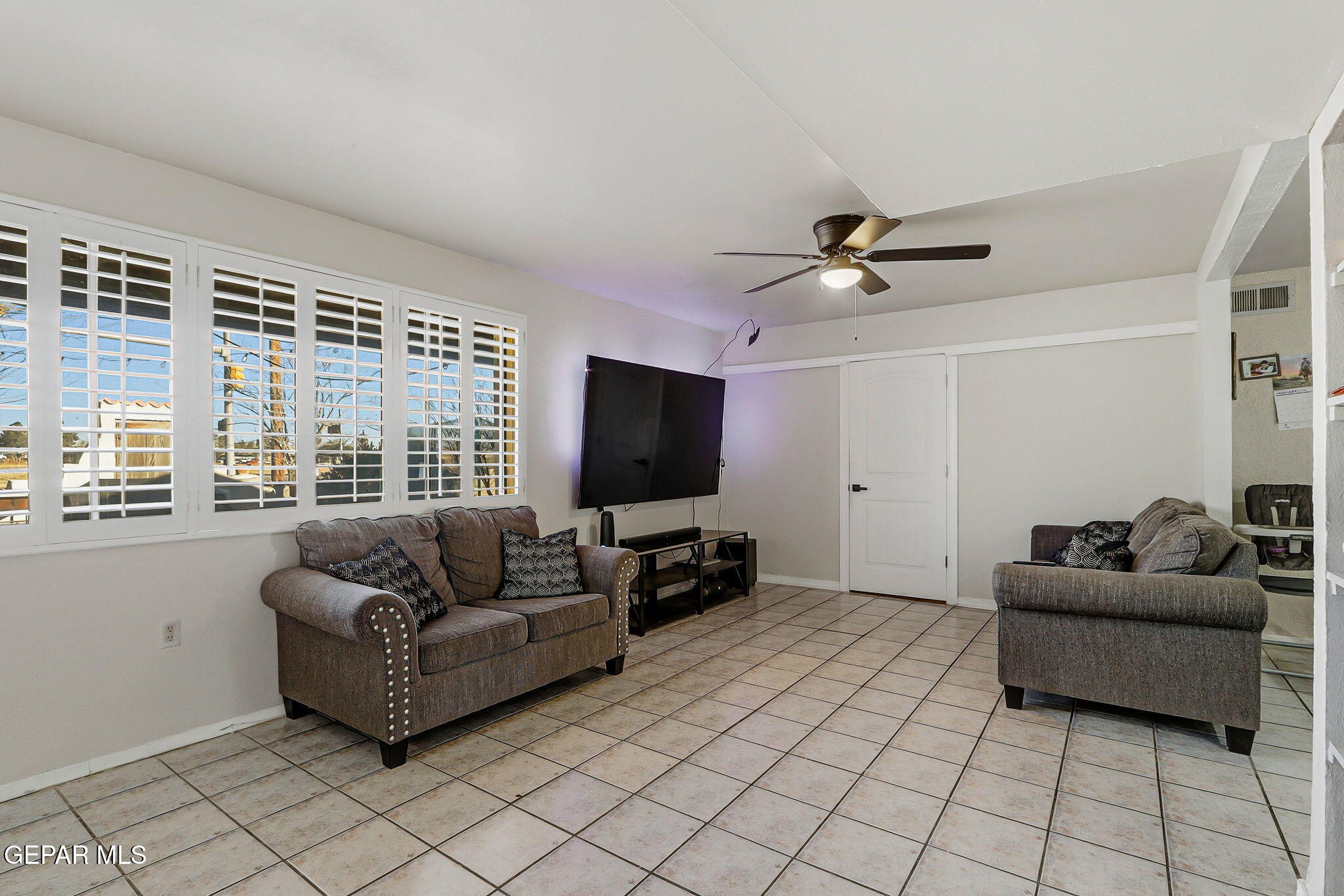 10540 Socorro Road Socorro, TX 79927 - Photo 7 of 45 a living room with furniture and a flat screen tv
