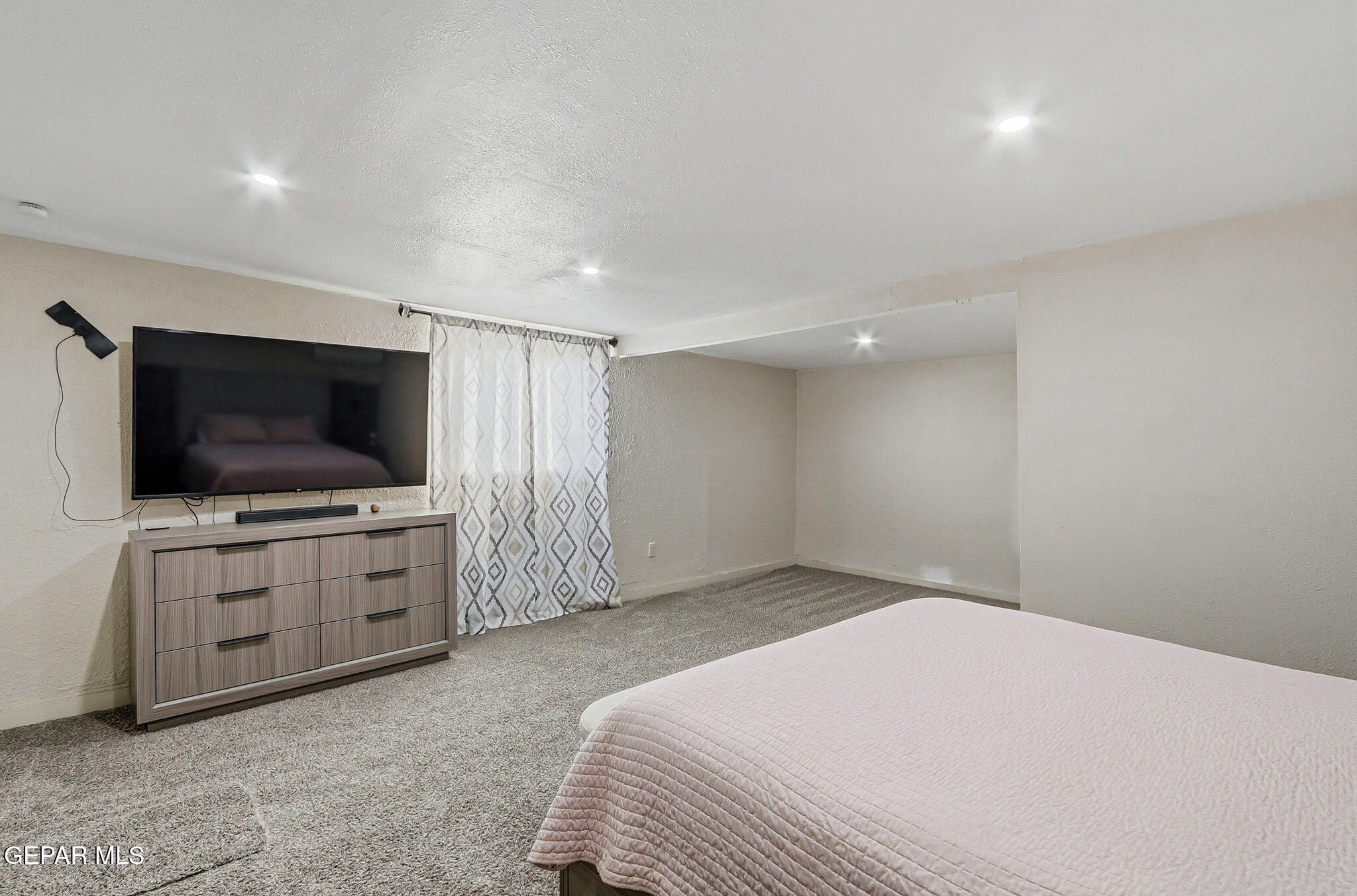 10540 Socorro Road Socorro, TX 79927 - Photo 10 of 45 a bedroom with a bed and a flat screen tv