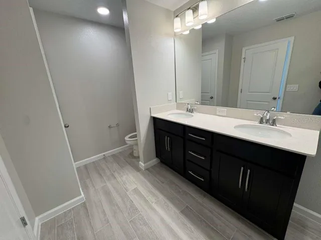 a bathroom with a sink and toilet
