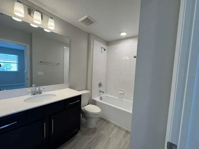 an empty room with closet and mirror