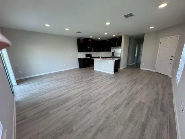 a kitchen with stainless steel appliances kitchen island wooden cabinets and granite counter tops