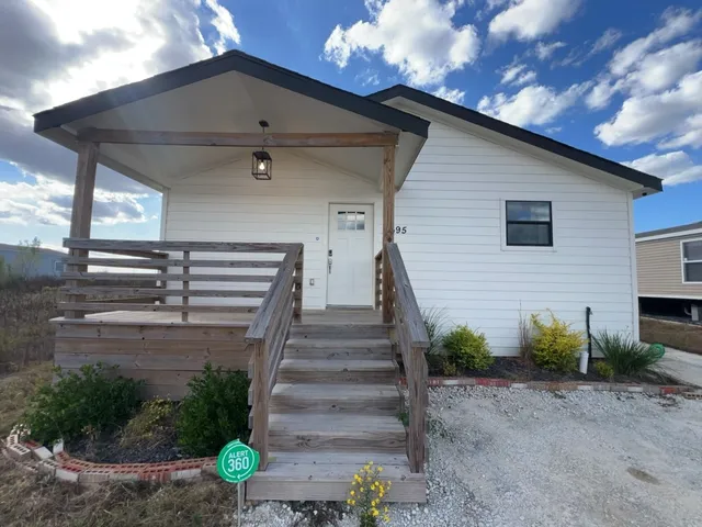 a front view of a house with plants and garage
