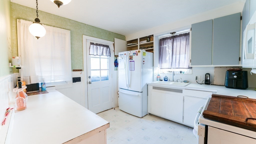 181 Laurelton Street Springfield, MA 01109 - Photo 6 of 17 a kitchen with white cabinets and white appliances