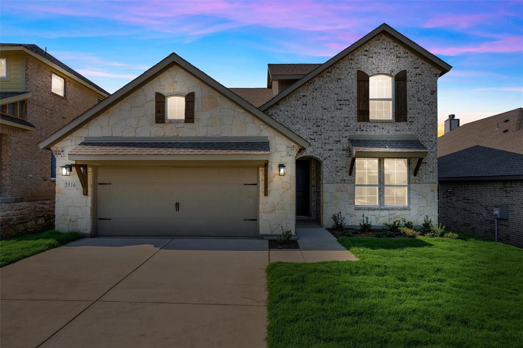 a front view of a house with a yard and garage