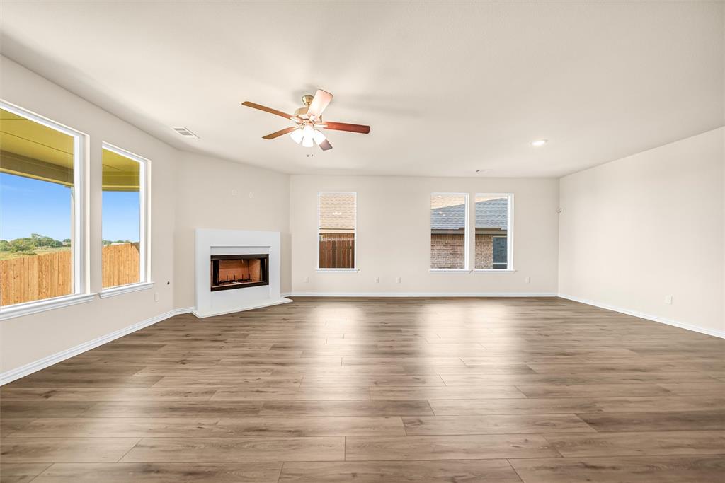 3516 Columbus Street Gainesville, TX 76240 - Photo 15 of 40 a view of an empty room with window and wooden floor