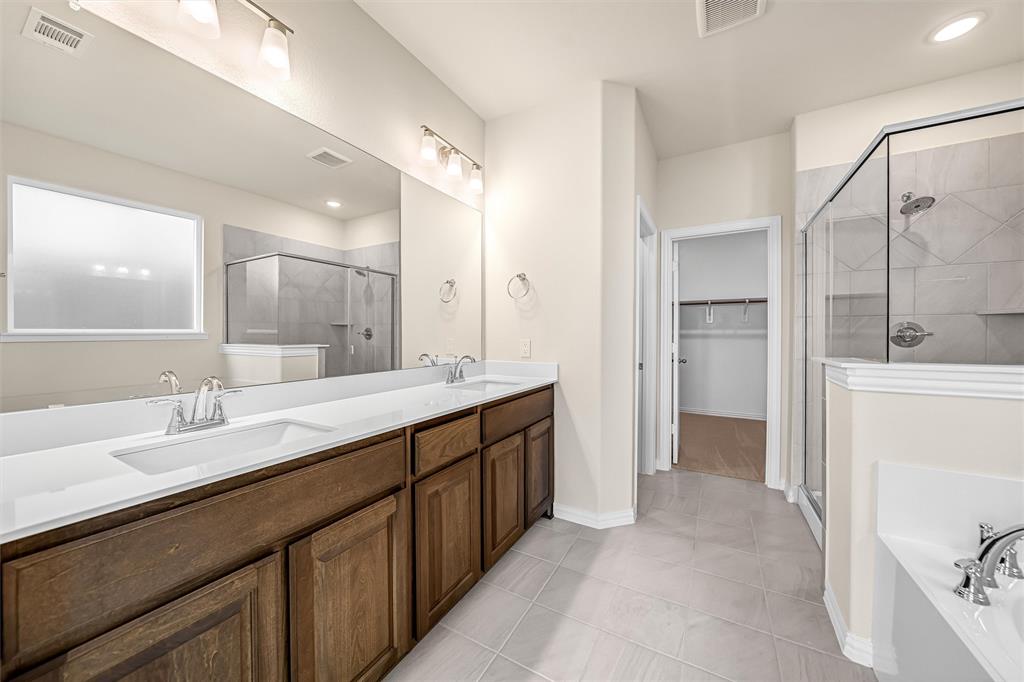 3516 Columbus Street Gainesville, TX 76240 - Photo 18 of 40 a bathroom with a double vanity sink mirror and double