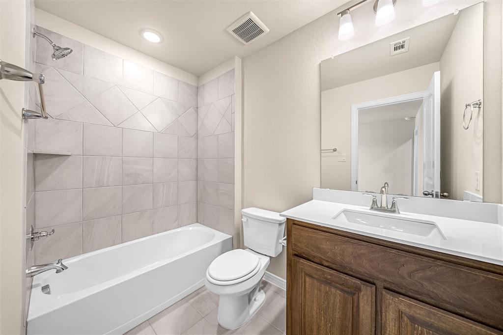 3516 Columbus Street Gainesville, TX 76240 - Photo 32 of 40 a bathroom with a sink a toilet and bathtub