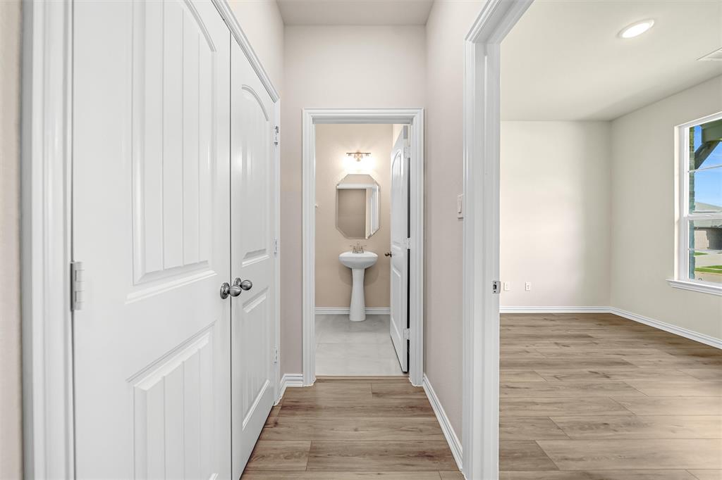 3516 Columbus Street Gainesville, TX 76240 - Photo 9 of 40 a view of a hallway with wooden floor and a bathroom