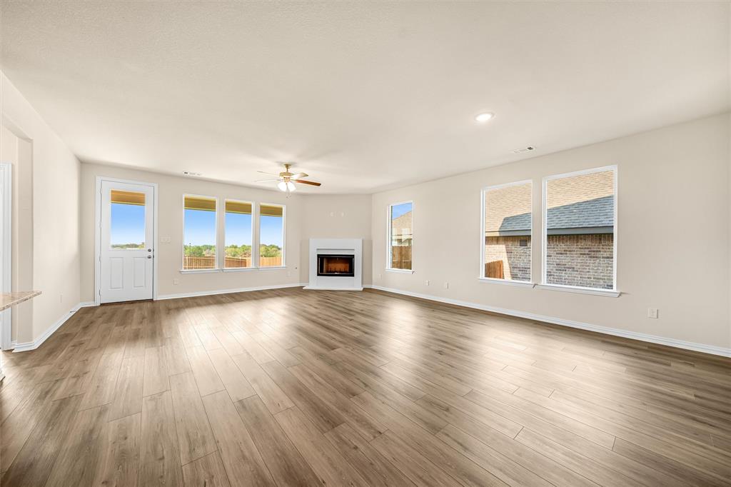 3516 Columbus Street Gainesville, TX 76240 - Photo 10 of 40 an empty room with wooden floor and windows