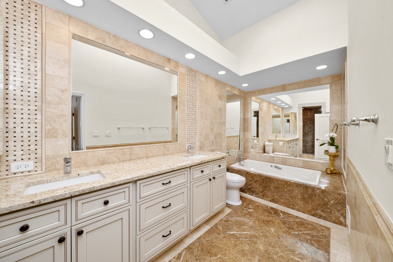 55 West Goethe Street, Unit 1222 Chicago, IL 60610 - Photo 22 of 43 a spacious bathroom with a granite countertop sink mirror and a bath tub