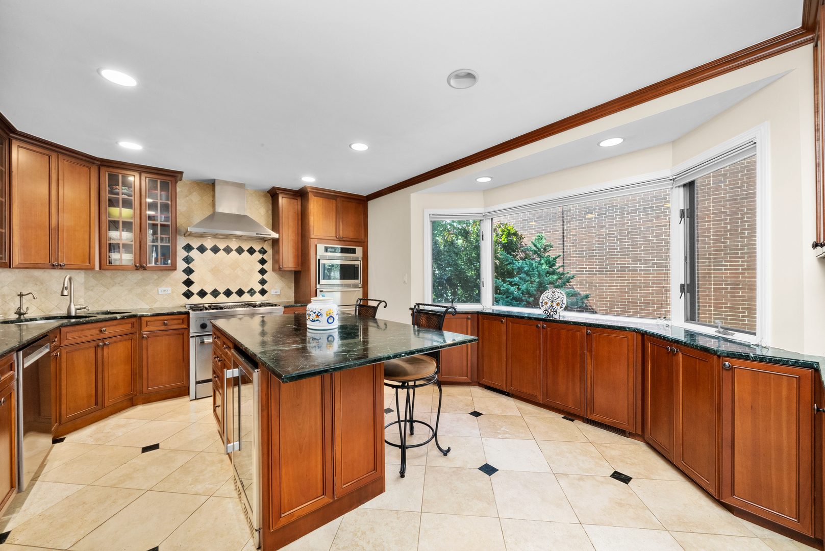 55 West Goethe Street, Unit 1222 Chicago, IL 60610 - Photo 3 of 43 a kitchen with stainless steel appliances granite countertop a sink counter space cabinets and a large window