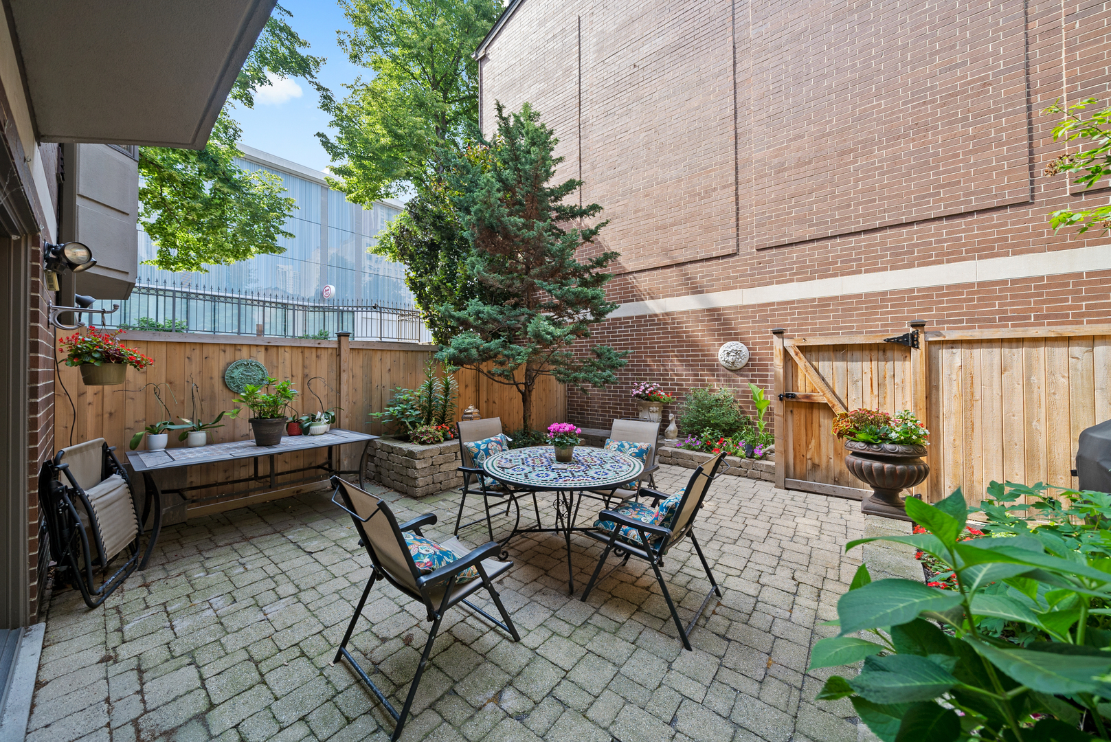 55 West Goethe Street, Unit 1222 Chicago, IL 60610 - Photo 35 of 43 a view of a patio with table and chairs potted plants and floor to ceiling window
