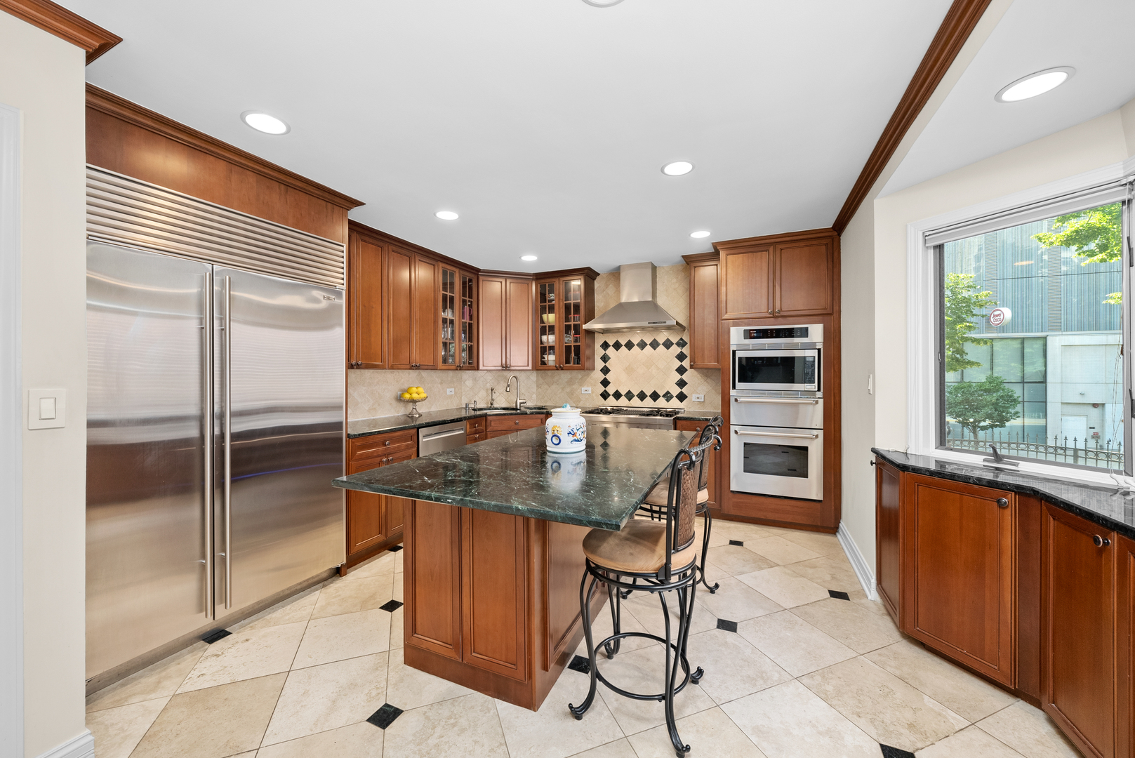 55 West Goethe Street, Unit 1222 Chicago, IL 60610 - Photo 4 of 43 a kitchen with stainless steel appliances granite countertop a refrigerator and a stove top oven