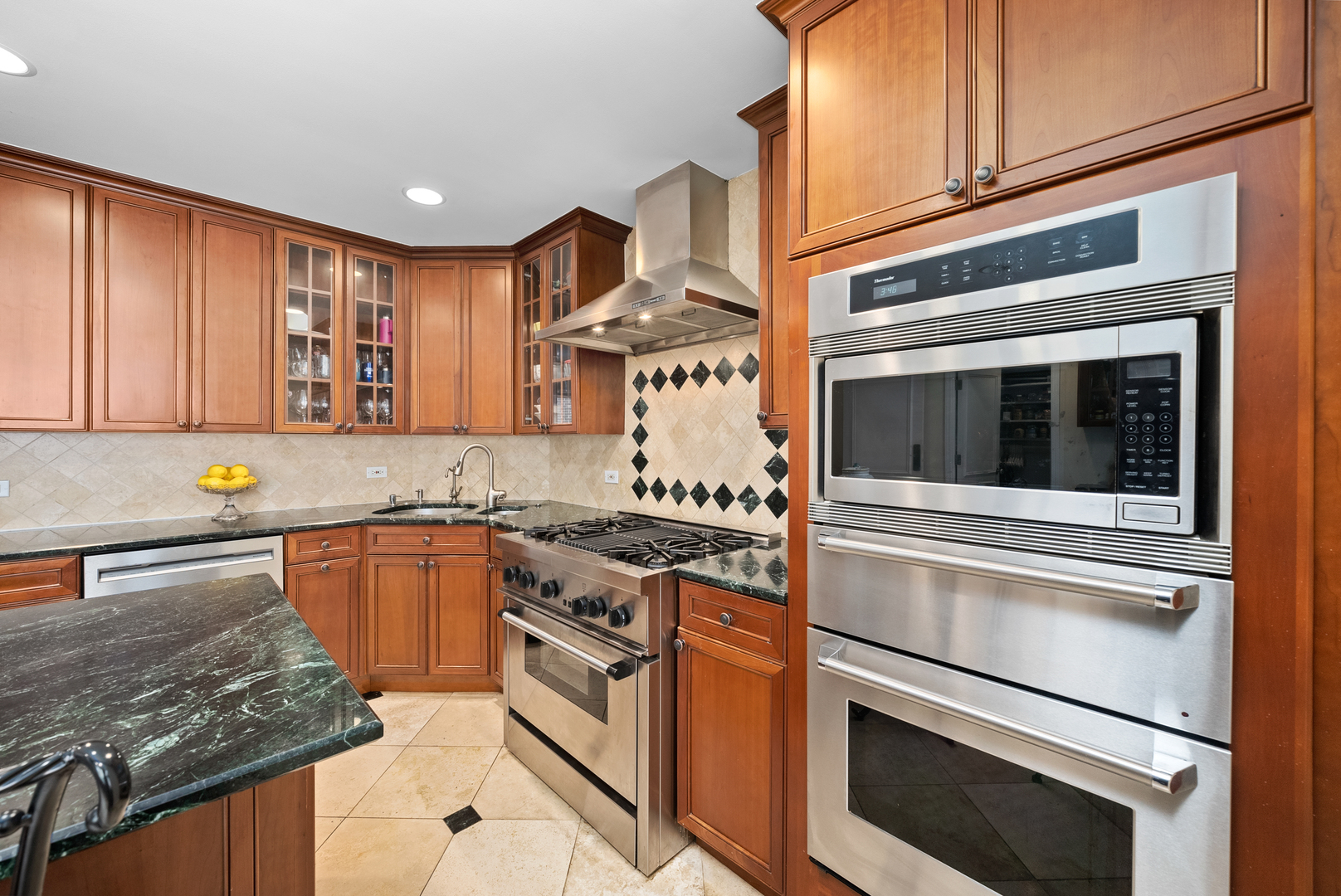 55 West Goethe Street, Unit 1222 Chicago, IL 60610 - Photo 5 of 43 a kitchen with stainless steel appliances granite countertop a stove and a microwave