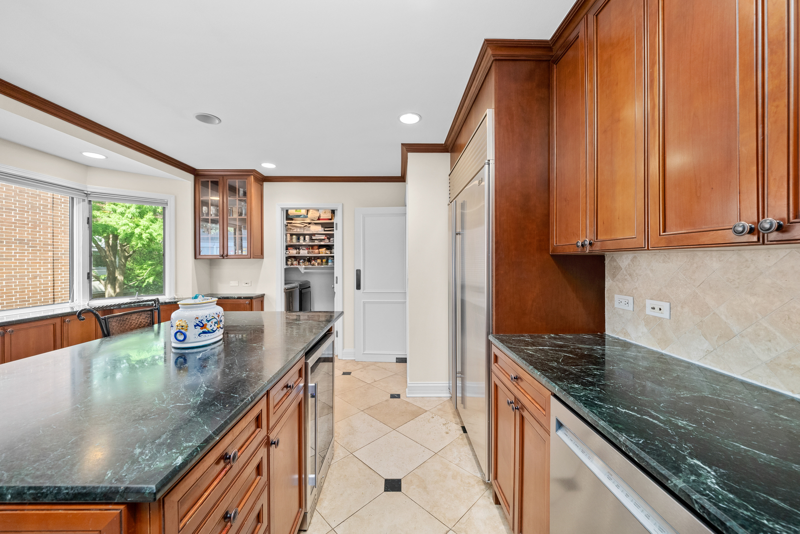 55 West Goethe Street, Unit 1222 Chicago, IL 60610 - Photo 6 of 43 a kitchen with stainless steel appliances granite countertop a sink and a counter space