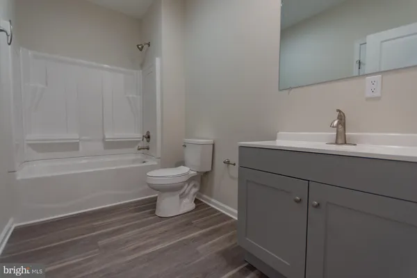 a bathroom with a sink toilet a toilet and vanity