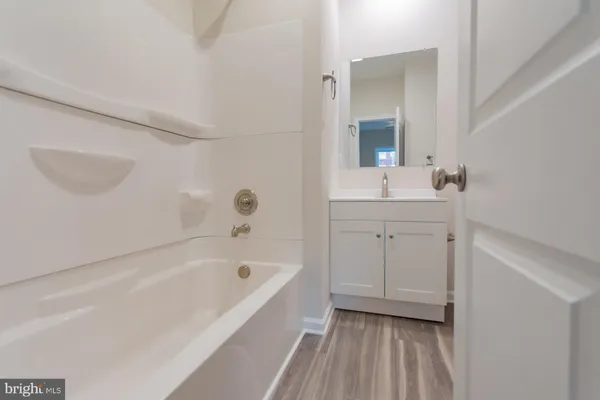 a bathroom with a bathtub and a sink