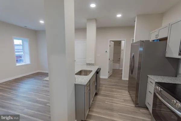 a kitchen with stainless steel appliances a refrigerator and a stove