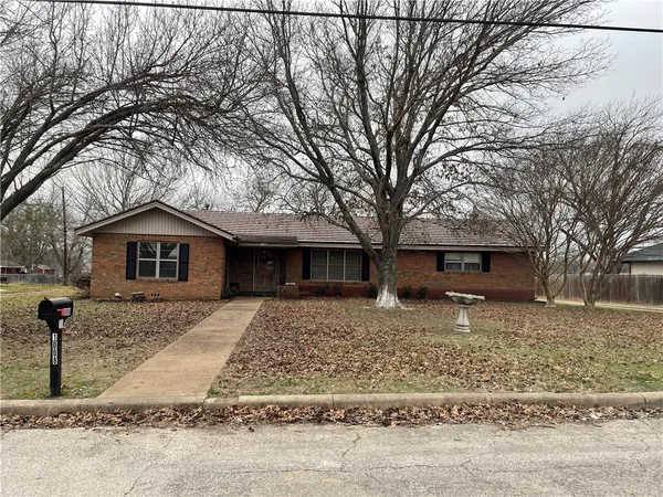 a house with trees in the background