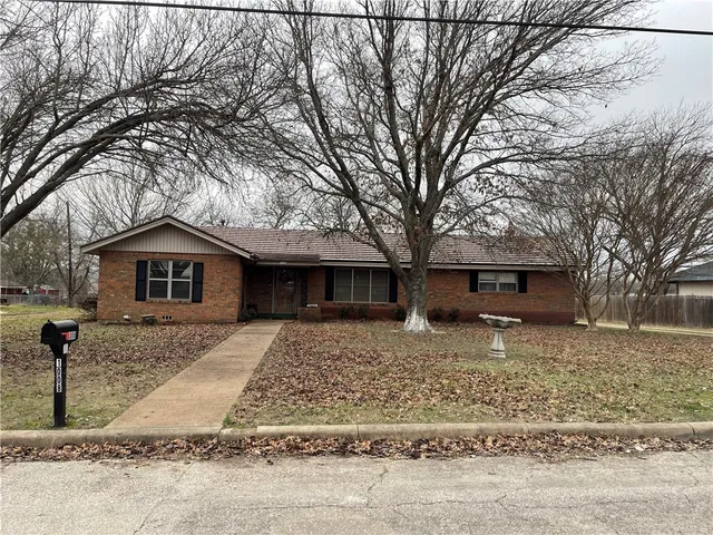 a house with trees in the background