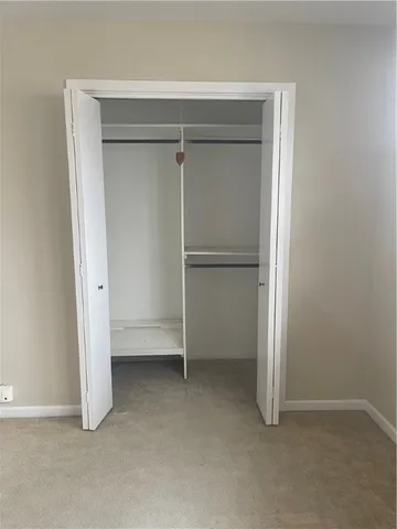 an empty room with a chandelier fan