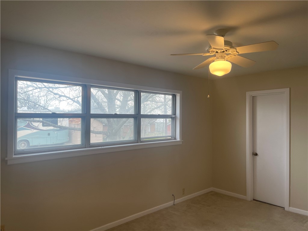 1008 North Bosque Street Meridian, TX 76665 - Photo 13 of 36 an empty room with windows and fan