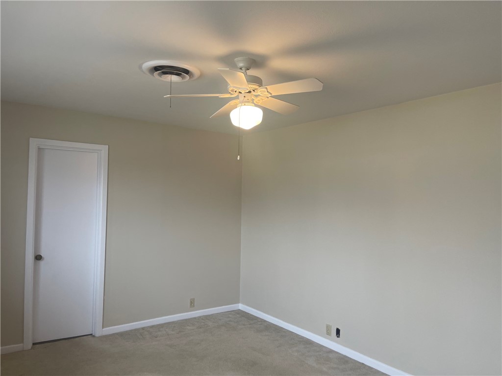 1008 North Bosque Street Meridian, TX 76665 - Photo 14 of 36 an empty room with a fan & a window