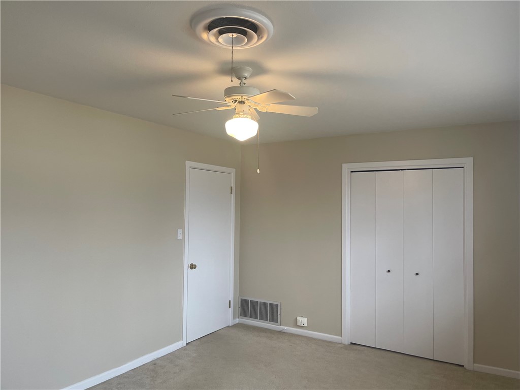 1008 North Bosque Street Meridian, TX 76665 - Photo 15 of 36 an empty room with a chandelier fan